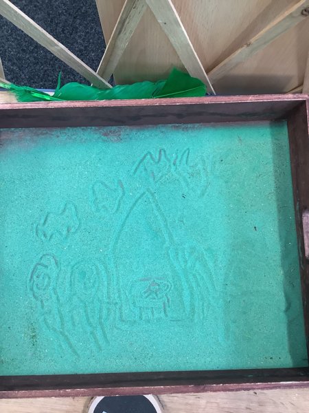 Image of Drawing the nativity scene in the sand!